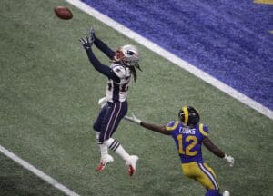 New England Patriots' Stephon Gilmore (24) prepares to intercept the ball against Los Angeles Rams' Brandin Cooks (12) during the second half of the NFL Super Bowl 53 football game Sunday, Feb. 3, 2019, in Atlanta. (AP Photo/Charlie Riedel)