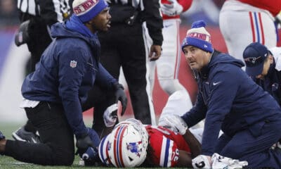 New England Patriots running back Rhamondre Stevenson is attended to by medical staff during the first half of an NFL football game against the Los Angeles Chargers, Sunday, Dec. 3, 2023, in Foxborough, Mass. (AP Photo/Michael Dwyer)