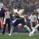 Chicago Bears quarterback Justin Fields (1) plays against the New England Patriots during the first half of an NFL football game, Monday, Oct. 24, 2022, in Foxborough, Mass. (AP Photo/Michael Dwyer)