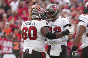 Tampa Bay Buccaneers quarterback Tom Brady (12) celebrates his rushing touchdown with Tampa Bay Buccaneers guard Nick Leverett (60) during an NFL football game against the Carolina Panthers, Sunday, January 1, 2023, in Tampa, Fla. (AP Photo/Peter Joneleit)