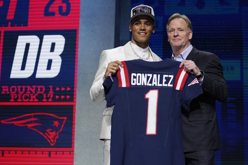 Oregon defensive back Christian Gonzalez, left, poses with NFL Commissioner Roger Goodell after being chosen by the New England Patriots with the 17th overall pick during the first round of the NFL football draft, Thursday, April 27, 2023, in Kansas City, Mo. (AP Photo/Jeff Roberson)