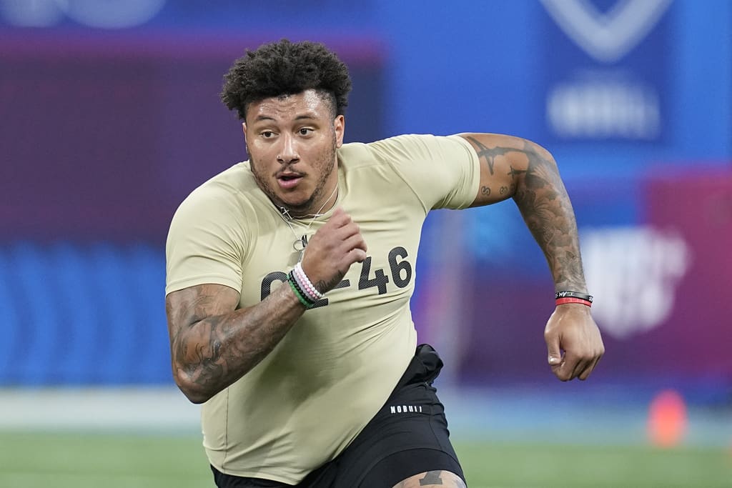 Boston College offensive lineman Christian Mahogany runs a drill at the NFL football scouting combine, Sunday, March 3, 2024, in Indianapolis. (AP Photo/Darron Cummings)