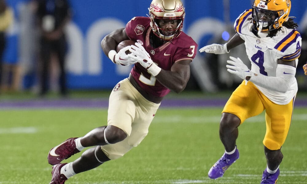 NFL Draft prospect, Florida State running back Trey Benson (3) runs for yardage against LSU linebacker Harold Perkins Jr. (4) during the second half of an NCAA college football game Sunday, Sept. 3, 2023, in Orlando, Fla. (AP Photo/John Raoux)