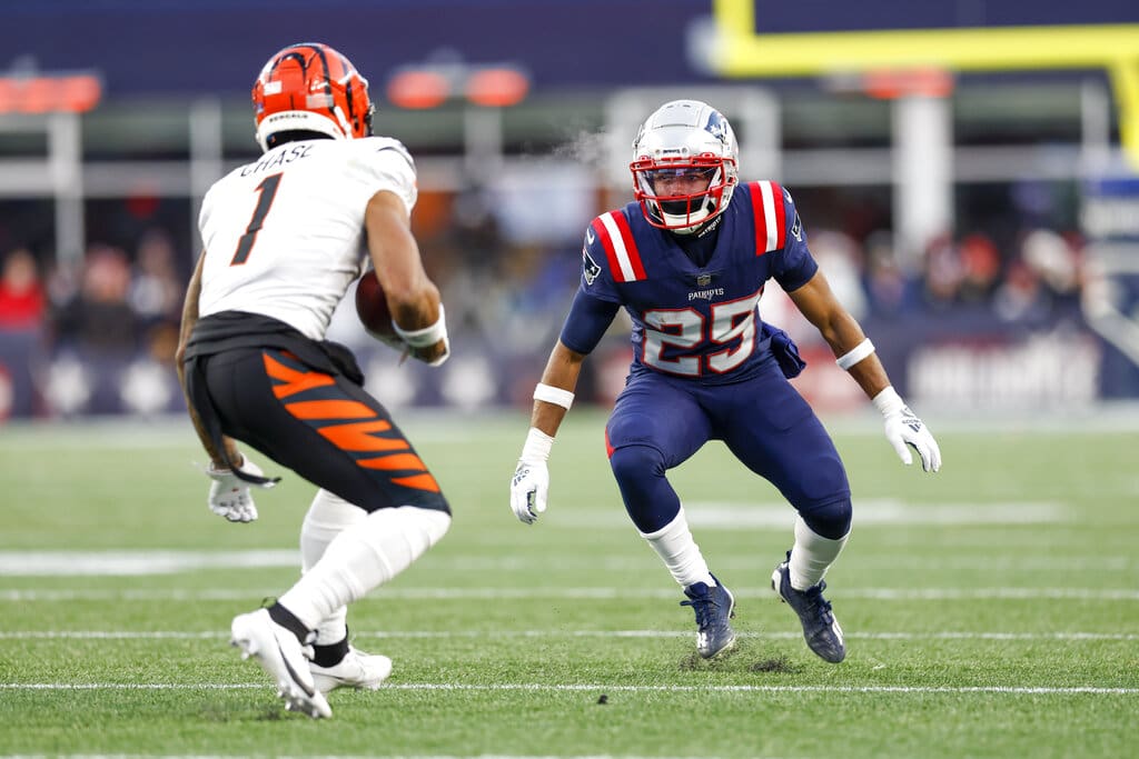Cincinnati Bengals wide receiver Ja'Marr Chase (1) is defended by New England Patriots cornerback Marcus Jones (25) during the second half of an NFL football game, Saturday, Dec. 24, 2022, in Foxborough, Mass. (AP Photo/Greg M. Cooper)
