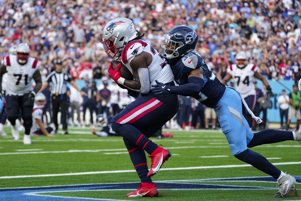 New England Patriots running back Rhamondre Stevenson (38) makes a catch in front of Tennessee Titans cornerback Darrell Baker Jr. (39) for a touchdown at the end of the fourth quarter of an NFL football game in Nashville, Tenn., Sunday, Nov. 3, 2024. (AP Photo/George Walker IV)